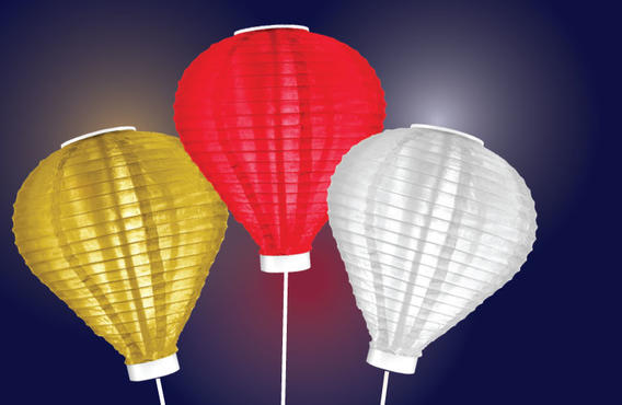 3 lit up lanterns. 1 gold, 1 red, and 1 white