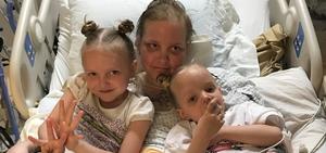 Picture of Alayla in hospital with two children 